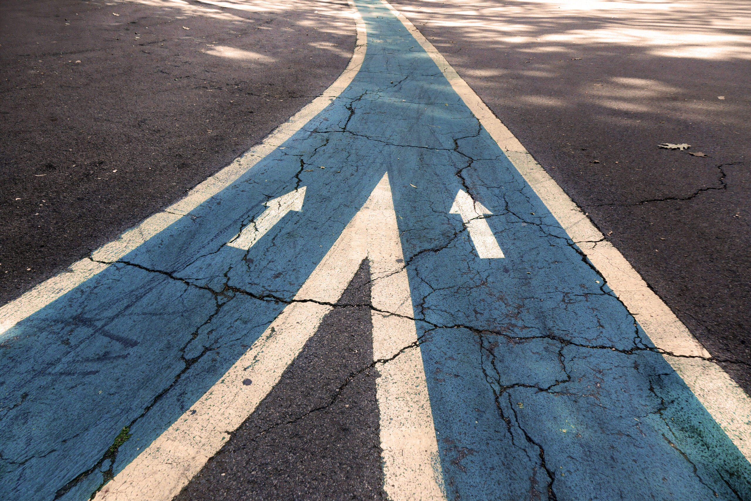 image of Merging asphalt road with arrow signs